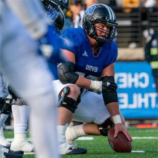 Center gets in position to snap the football.